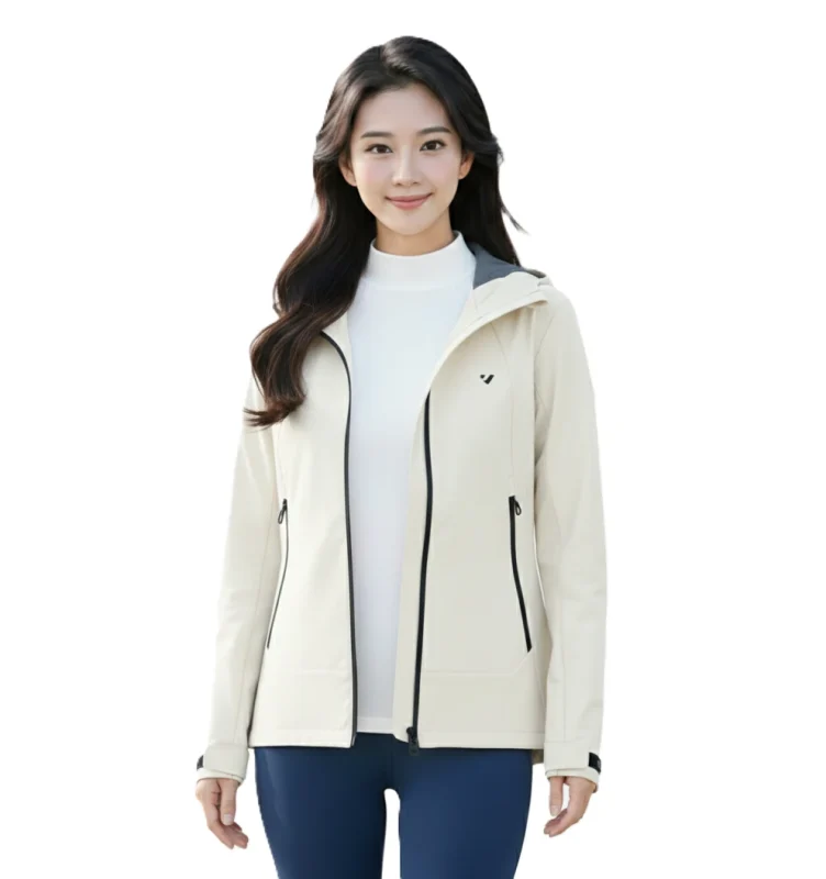 一名亞洲女性穿著米白色連帽機能夾克，左胸是KOMIA 品牌LOGO，內搭白色高領上衣與深藍色瑜珈褲。